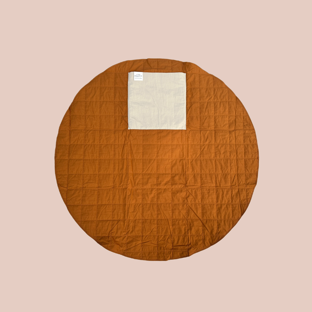 sustainable waterproof anytime rug. the perfect play mat or picnic rug in bark colour. round 1.3m diameter. folds up into its own inbuilt pocket.