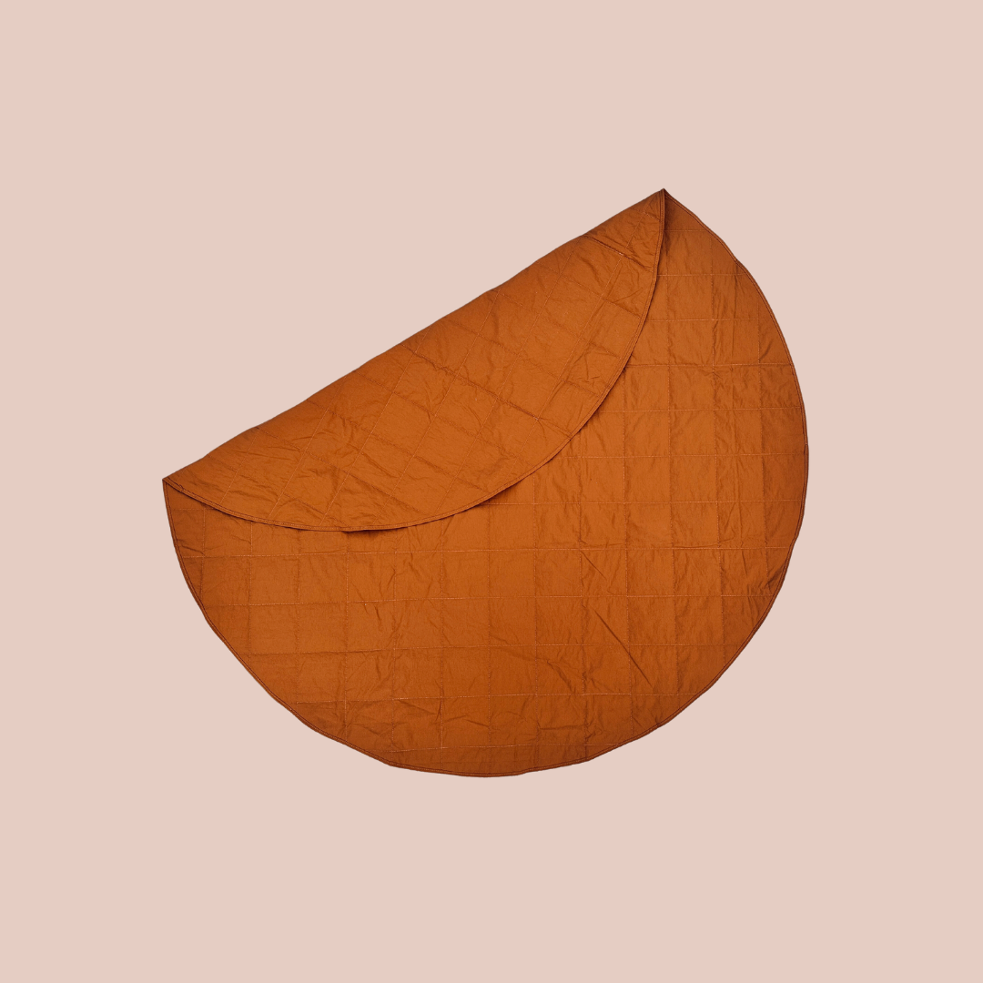 sustainable waterproof anytime rug. the perfect play mat or picnic rug in bark colour. round 1.3m diameter. folds up into its own inbuilt pocket.