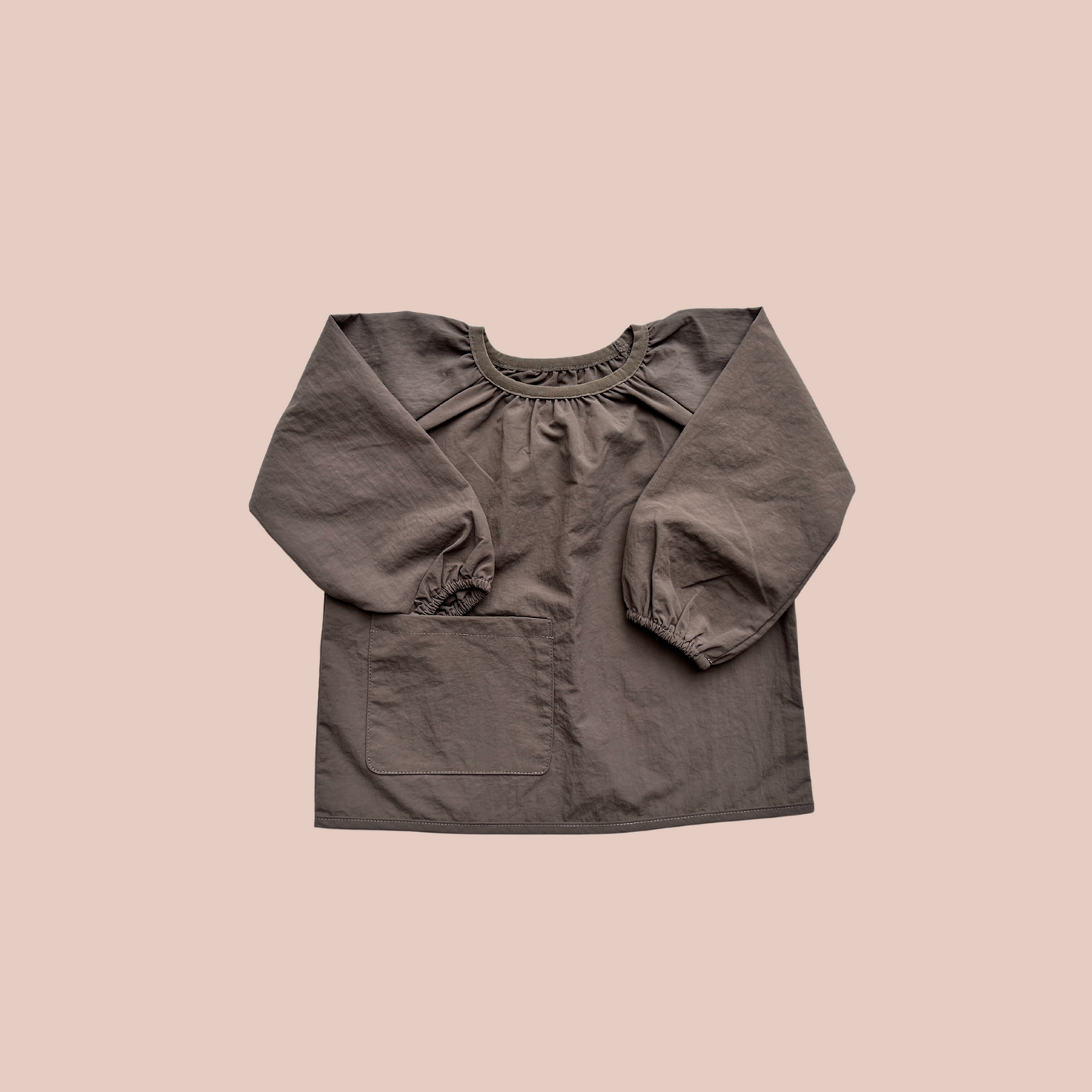 100% recycled nylon water resistant smock. lightweight and quick drying, elastic neckline and wrist, signature inbuilt pocket