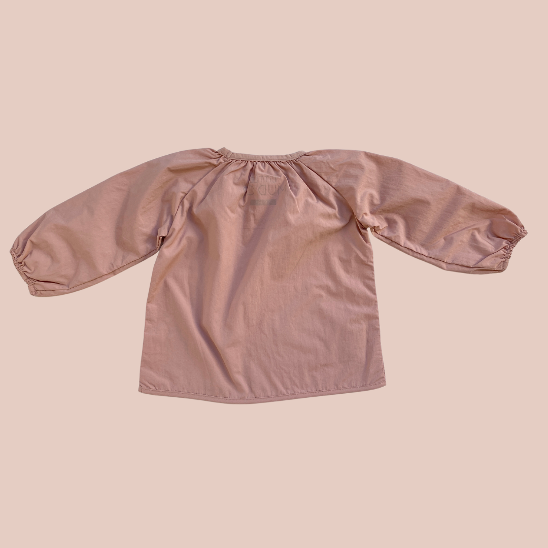 100% recycled nylon water resistant lightweight & quick drying elastic neckline and wrist signature mud pocket. pink blossom