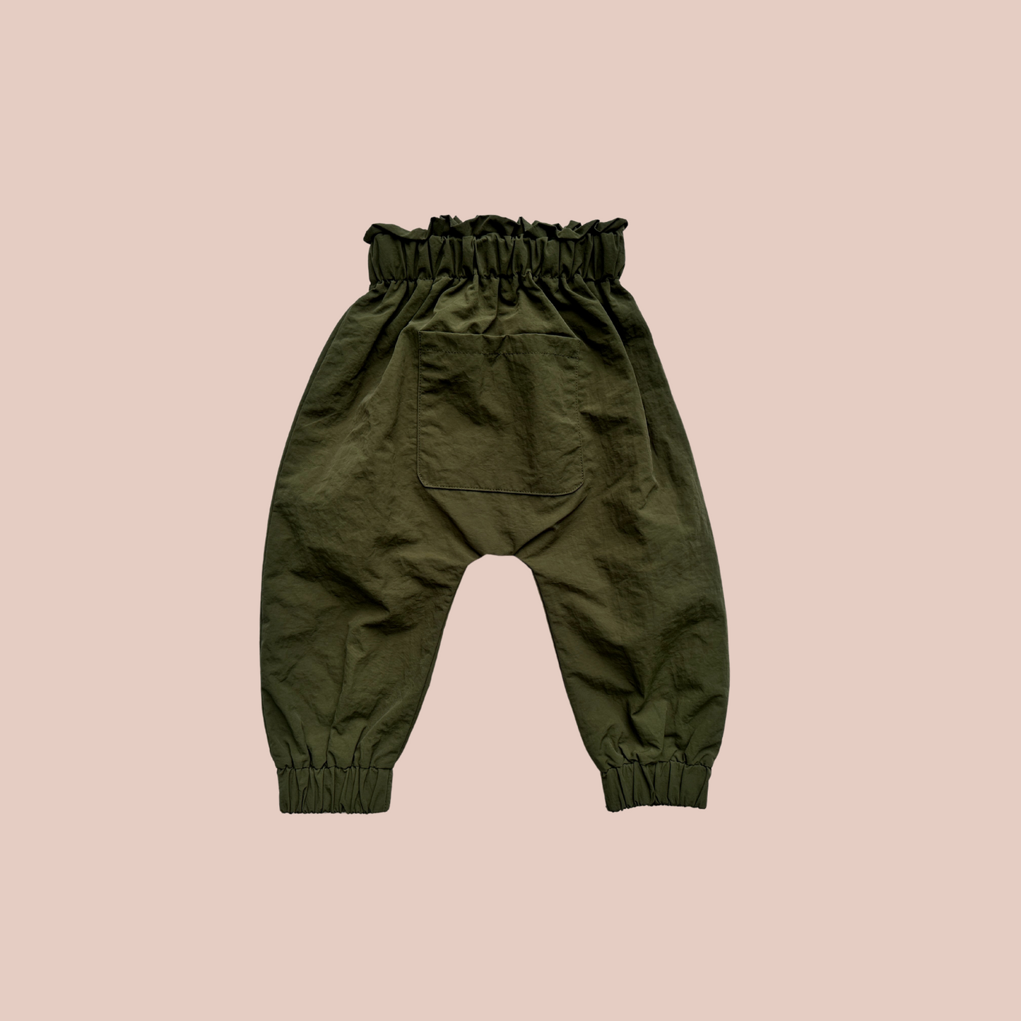 100% recycled nylon water resistant rain pants, lightweight and quick drying harem style leg with elastic waist and ankle, signature inbuilt pocket