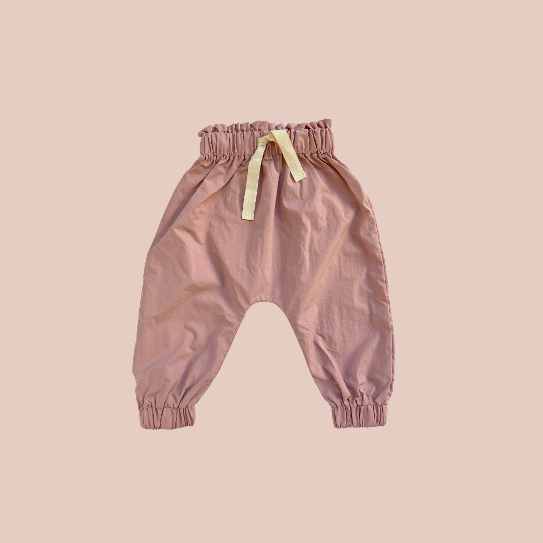 100% recycled nylon water resistant harem style leg elastic waist and ankle signature built in mud pocket. pink blossom