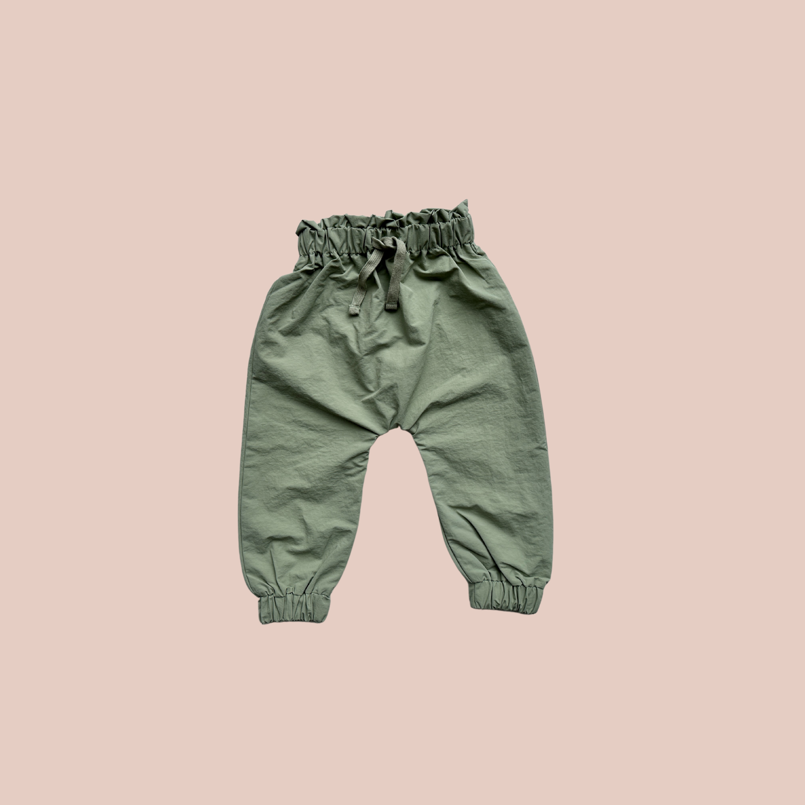 100% recycled nylon water resistant rain pants, lightweight and quick drying harem style leg with elastic waist and ankle, signature inbuilt pocket