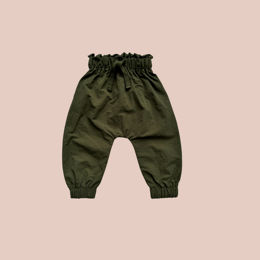 100% recycled nylon water resistant rain pants, lightweight and quick drying harem style leg with elastic waist and ankle, signature inbuilt pocket